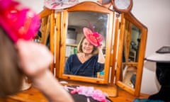 Milliner Anne Reeder, 77, tries on one of her creations in her home workshop.