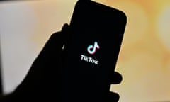 The TikTok app logo is seen on a phone