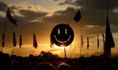 smiley face held above crowd