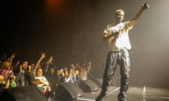 Danny Brown on stage at Village Underground, London, the audience raising an arm as he does