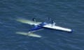 A screenshot obtained from a Nine News broadcast on 19 December 2021 shows a light plane in water off the coast of Redcliffe, Queensland