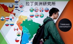 A student walks past a Latin American map at Tamkang University in Taipei.