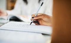 A woman takes notes in a book