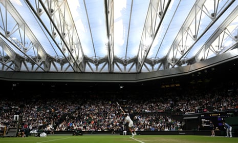 Novak Djokovic fires down a serve under the roof on Centre Court.