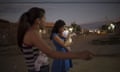 A pregnant woman holds a friend's daughter born with microcephaly in Brazil.