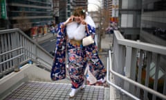 A woman leaves a coming of age ceremony, which are currently held when people reach the age of 20