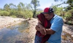 Francisco Sical hugs his daughter Melissa on the banks of the drying Salamá River in their Mayan village in Guatemala. They were subjected to the Trump administration's Migrant Protection Protocols in May 2019 and spent two months in Juárez at the U.S.-Mexico border before returning home, defeated.