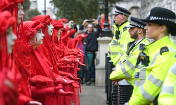 Protesters, dubbed the Red Rebels, outside the Cabinet Office on Whitehall, during an Extinction Rebellion (XR) protest in Westminster, London. Monday October 7, 2019.