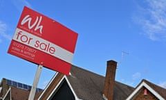 a red for sale sign set against a light blue sky