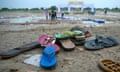 Shoes on the ground with people pictured in the background