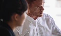 Close up shot of young man in meeting with female colleague, focus on businessman face.<br>H2MTDX Close up shot of young man in meeting with female colleague, focus on businessman face.