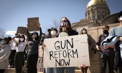 A woman advocates for stricter gun reform laws at a rally at the Georgia state capitol in the wake of the shootings at three spas in Atlanta. 