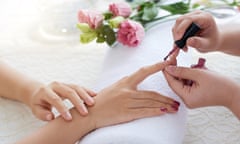 Woman having her nails painted with mauve polish