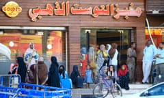 People line up outside a bakery in Khartoum, Sudan