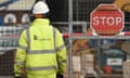 A Carillion worker next to a stop sign