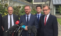 Simon Hamilton, of the DUP, (second left) at Stormont Castle, Belfast