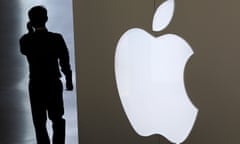 A man talking on his smartphone walks into an Apple store