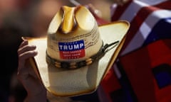 A Donald Trump supporter in Pittsburgh waves his hat at a pre-election rally