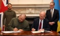 The defence secretary, John Healey, signs a credit agreement with Ukraine’s defence minister, Rustem Umerov, in London on 19 July 2024, as Keir Starmer, right, and Volodymyr Zelenskiy look on.