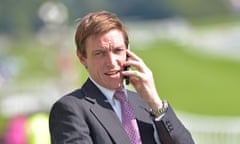 Richard Hughes, the former champion jockey, waiting to watch his first runner as a trainer at Epsom