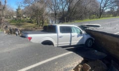 A truck rests in the sinkhole.