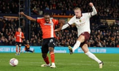 Manchester City's Erling Haaland holds off Teden Mengi to score their second goal