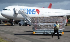 Boxes of face masks are unloaded from a plane bearing the logo ‘Thank you NHS’