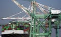 A cargo ship stacked with shipping containers is docked at the Port of Los Angeles