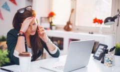 Young woman using cell phone at desk