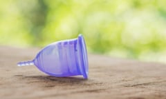 Feminine hygiene product - Menstrual cup On a wooden background.