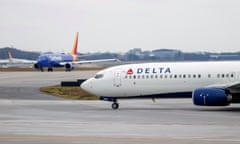 delta air lines plane on tarmac with another plane behind it