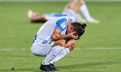 Leganés players crumple on the pitch after their relegation.