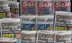 Tabloid papers at a newsstand