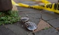 Police crime tape is seen near a pair of American flag-themed sunglasses on the ground at the scene of the Fourth of July parade shooting in Highland Park, Illinois.