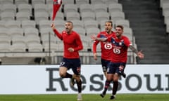 Lille’s Burak Yilmaz (left) leads the celebrations by running with his shirt in the air after scoring his side’s third goal in the 85th minute.