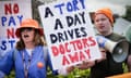 People in orange BMA hats hold a sign reading 'A Tory a day drives doctors away'.
