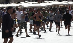 Russian fans run at England fans as they clash ahead of the game against Russia on June 11, 2016 in Marseille, France.