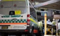 Ambulance crew prepares a gurney to transport aged care residents to hospital in Sydney, Australia