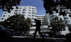 A pedestrian walks across the street from the building where a technology executive was fatally stabbed outside of in San Francisco, Thursday, April 6, 2023. Details of how tech executive Bob Lee came to be fatally stabbed in downtown San Francisco early Tuesday were scarce as friends and family continued to mourn the man they called brilliant, kind and unlike others in the industry. (AP Photo/Jeff Chiu)