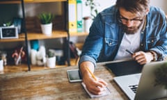 Man working in his modern home office on laptop