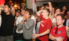 England fans watch the team play Belgium, at the Lord Raglan pub in central London.