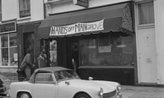 Four men entering the Mangrove, a Caribbean restaurant on All Saints Road, Notting Hill, London, 10 August 1970. The restaurant is seen here with a banner reading: 'Hands Off Mangrove' above it