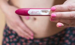 Woman holding a pregnancy test