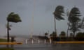 Palm trees sway as the wind and rain from Hurricane Beryl pass through Kingston, Jamaica. 