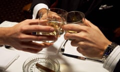 Men in suits toasting with whisky