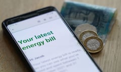 Energy bill on a smartphone next to some money