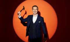 Comedian Jimmy Carr wielding a hammer