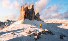 Tourist admiring the Three Peaks of Lavaredo in winter, Italy<br>GettyImages-1317239062