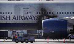 A damaged British Airways Boeing 777-200 sits at McCarran International Airport Wednesday, Sept. 9, 2015, in Las Vegas. An engine caught fire before takeoff Tuesday forcing the evacuation of the crew and passengers. (AP Photo/John Locher)