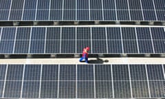 Worker checking solar panels